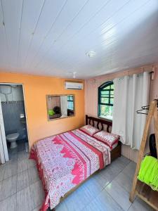 a bedroom with a large bed and a bathroom at Pousada e Camping Rhaiana in Ilha do Mel