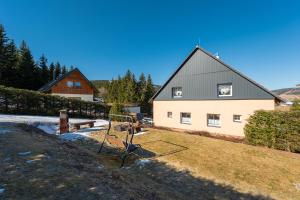 a house with a basketball hoop in front of it at Apartmány Happy Klínovec in Loučná pod Klínovcem +26 photos