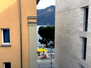 a view of a body of water from between two buildings at San Carlo Luxury Apartments in Lugano