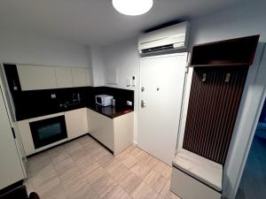 a small kitchen with a white and black kitchen at San Carlo Luxury Apartments in Lugano