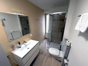 a bathroom with a toilet and a sink and a shower at San Carlo Luxury Apartments in Lugano