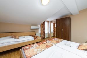 a bedroom with two beds in a room at Penzion Siesta in Vráble