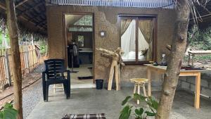 a room with a table and a chair and a mirror at RURAL CLAY HOUSE Hiriketiya in Hiriketiya +17 photos
