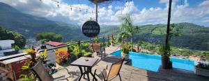 a balcony with a view of a pool and mountains at Rooftop in Xilitla