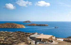 a view of the ocean with a boat in the water at Great View, Tiny Hill-top house in Rámos