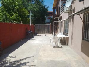 a white chair sitting on a sidewalk next to a building at CaSa VALENTINA PA in San Clemente del Tuyú