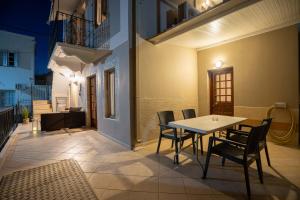 a patio with a table and chairs on a balcony at OURANIAS HOUSE in Kalymnos