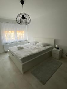Ένα ή περισσότερα κρεβάτια σε δωμάτιο στο Apartman Centar