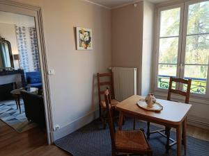 a dining room with a table and chairs and a window at B&B Girolles les Forges in Girolles +41 photos