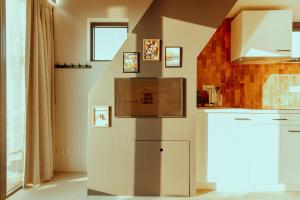 a kitchen with a stair case in the middle of a room at Venti Beach Houses in Zandvoort