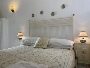 a bedroom with a large bed with two nightstands and two lamps at La Casa di Audrey in Capri