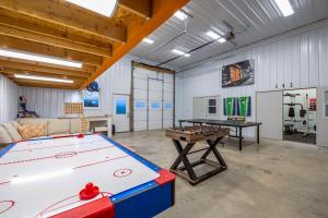 a room with a pool table and a table at Black Hills Barndo-Hot Tub & Massage Chair in Hermosa