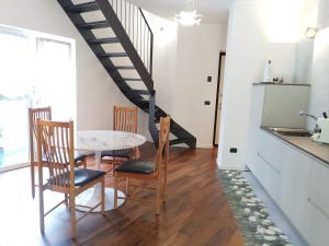 a kitchen and dining room with a table and chairs at Relaxing Break Lario in Gravedona