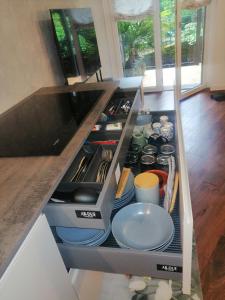 a kitchen counter with a drawer full of dishes at Relaxing Break Lario in Gravedona +43 photos