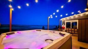 a jacuzzi tub in a room with lights at Black Hills Barndo-Hot Tub & Massage Chair in Hermosa