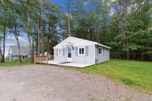 a white tiny house in a yard at Cottages 7 & 9 - Fire Pit - Beach - Sleeps 8 in Lincoln Junction