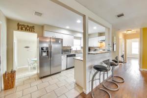a kitchen with a stainless steel refrigerator and bar stools at Welcoming Home about 6 Mi to Downtown San Antonio! in San Antonio +16 photos