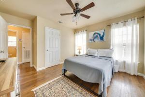 a bedroom with a bed and a ceiling fan at Welcoming Home about 6 Mi to Downtown San Antonio! in San Antonio