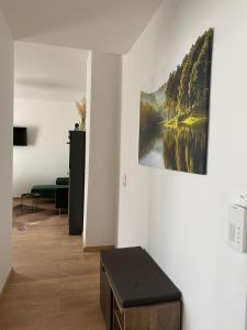 a living room with a painting on the wall at G Kennedy, 3 Personen Deluxe Markranstädt in Markranstädt