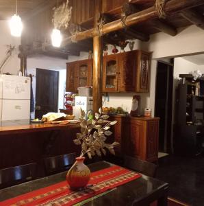 a kitchen with a table with a vase on it at Casa Mirador en la ciudad Inca Cusco in Cusco