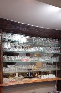 a shelf full of glasses on a wall at Un endroit au calme 72110 in Beaufay