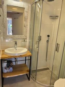 a bathroom with a sink and a shower at Domki Szelega in Pobierowo
