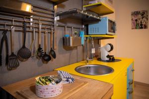 a kitchen with a sink and a counter with utensils at Baby Art Apartment in Arona