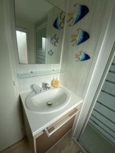 a white bathroom with a sink and a mirror at Les pieds dans l'eau in Le Portel +16 photos