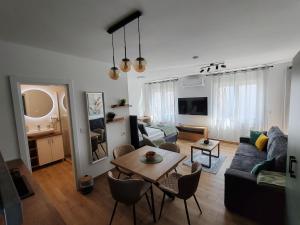 a living room with a couch and a table at Surčin Central Stay in Surčin