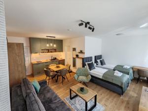 a living room with a bed and a couch at Surčin Central Stay in Surčin
