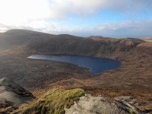 an aerial view of a lake in the mountains at The Mournes view Farmhouse in Newcastle