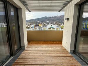 an empty balcony with a view of a town at Ferienwohnung am Schlosspark in Altmünster