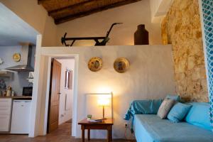 a living room with a blue couch and a table at Casas na Vinha - Monte da Casteleja, Wine Estate - Eco Turismo Rural in Lagos