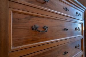 eine Kommode aus Holz mit einem Metallgriff in der Unterkunft La Casina Bianca in Santa Maria degli Angeli