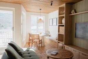 a living room with a couch and a table at BÕSKI - Refuge de luxe in Stoneham