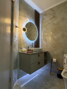 a bathroom with a sink and a mirror at eliTe deluxe 4 skyview in Kavála +43 photos