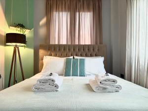 a bedroom with a bed with towels on it at eliTe deluxe 4 skyview in Kavála