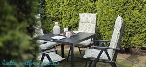 a black table with two chairs and a bottle of milk at luette oostfreesenstuuv in Holtgast