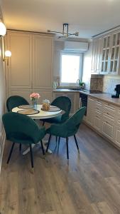 a kitchen with a table and chairs in a kitchen at Steaua ALBA CAROLINA in Alba Iulia +26 photos