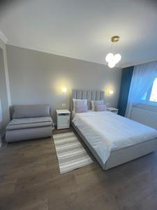 a bedroom with a large bed and a couch at Steaua ALBA CAROLINA in Alba Iulia