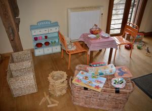 una sala giochi per bambini con tavolo e sala da pranzo di Cottage Mackinley, séjour spacieux et chaleureux, salon de jeux, grande salle à manger, contes,15 pers, Centre Historique, gare TER a Aubigny-sur-Nère Altre 48 foto