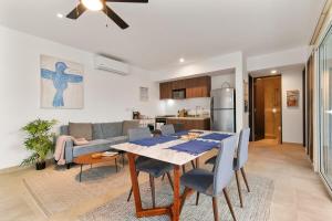 a dining room and kitchen with a table and chairs at Milagro 5 Minutes To Beach 2 Pools Private Balcony Gym in Tulum