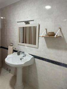 a bathroom with a sink and a mirror at CASA FAMILIAR LA ZUBIA - Granada in La Zubia +45 photos