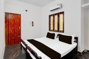 Postel nebo postele na pokoji v ubytování Hotel O Eswar Residency Avadi
