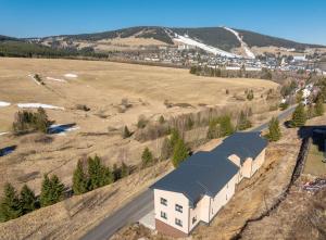 an aerial view of a building with a field at Apartmány Na Výhledech in Loučná pod Klínovcem