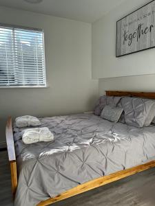 a bedroom with a bed with two pillows on it at Westshore Garden Escape in Victoria