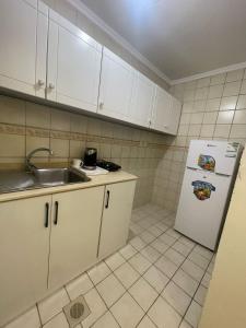 a kitchen with a sink and a refrigerator at وحدات سكنية مفروشة in Jeddah +35 photos