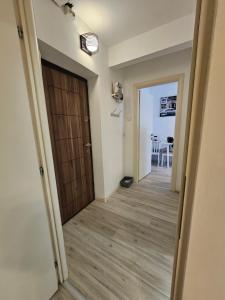 a hallway with a wooden door and a table at Central Crib in Iaşi
