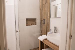 a bathroom with a sink and a shower at Lmholiday SUNSET apartment in Torre Canne