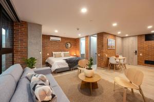 a living room with a couch and a bed in a room at Kyux Studios by MOME in Medellín +82 photos